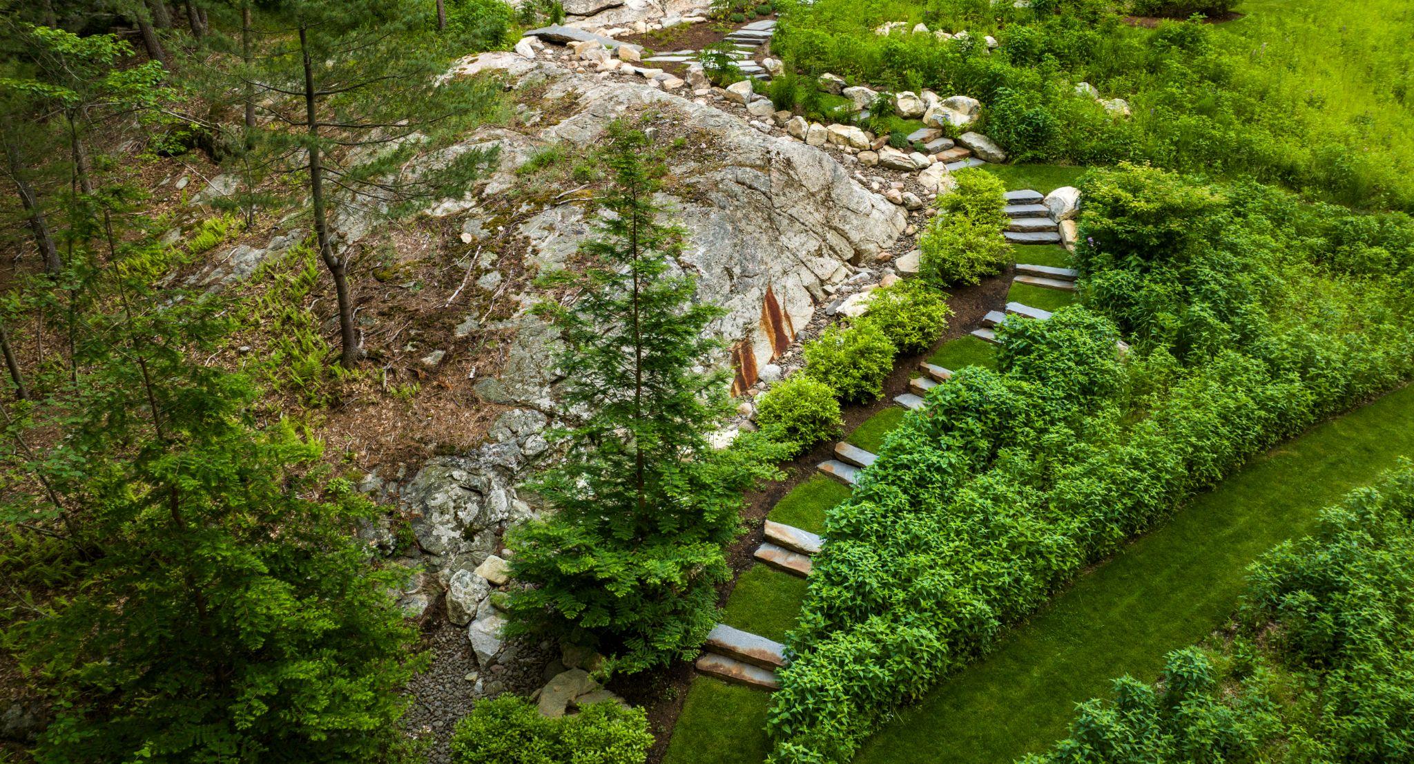 Terraced garden with stone steps integrated into a natural hillside
